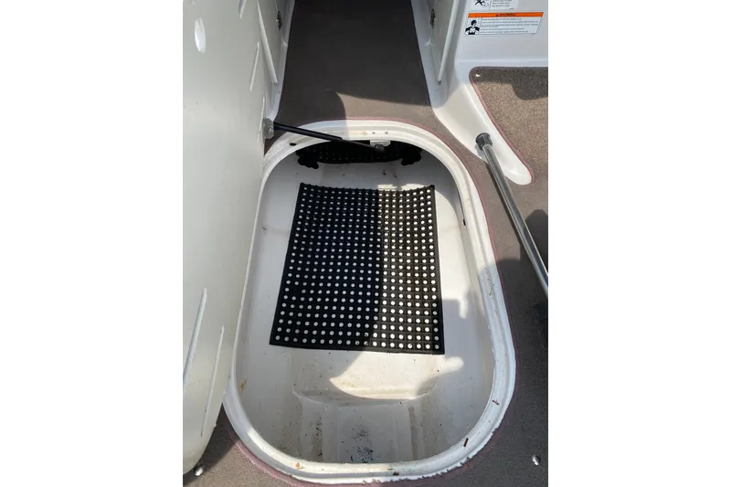 Slide: The Image of Ski locker compartment of 2008 Four Winns H220 boat with black mat inside. - 75
