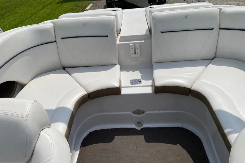 Slide: The Image of 2008 Four Winns H220 boat interior with white cushioned seating. - 25