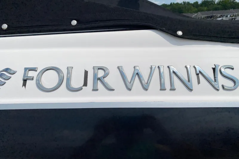 Slide: The Image of 2008 Four Winns H220 boat logo in shiny silver lettering on a white background. - 18