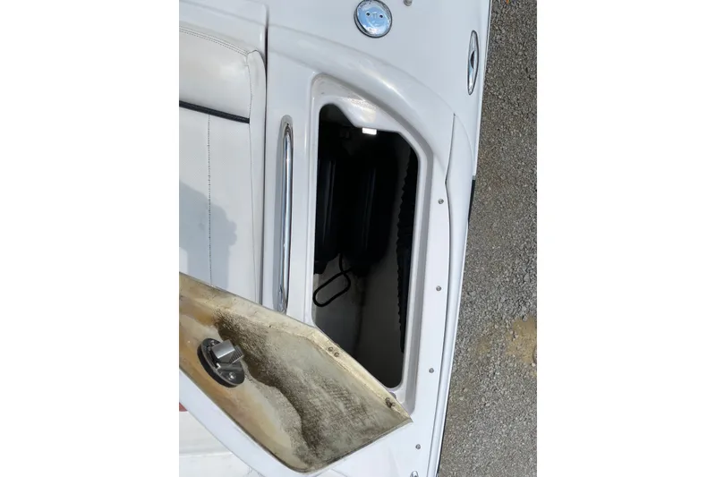 Slide: The Image of Open storage compartment on a 2008 Four Winns H220 boat, showing interior details. - 35