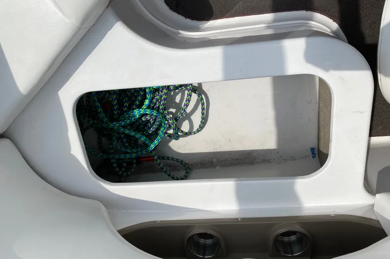 Slide: The Image of Storage compartment with colorful rope on a 2008 Four Winns H220 boat. - 38