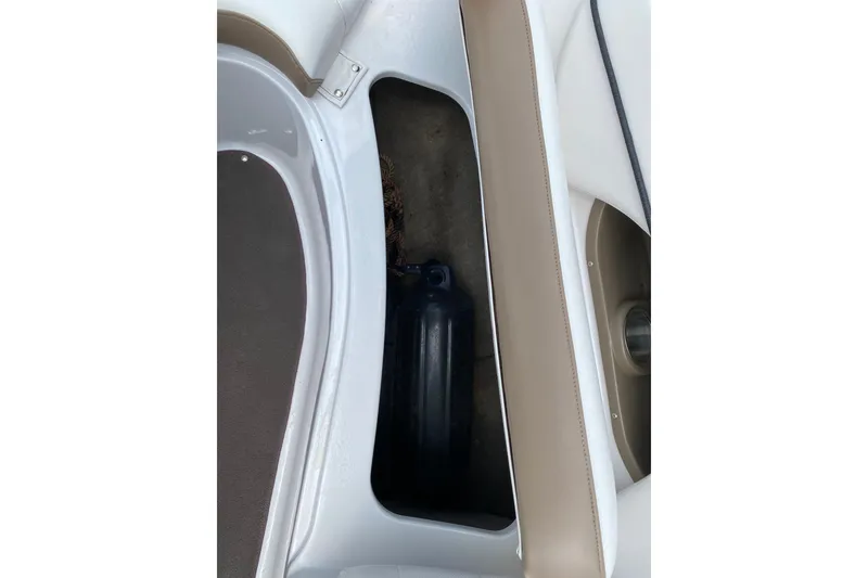 Slide: The Image of Storage compartment in a 2008 Four Winns H220 boat, featuring a black fender. - 77