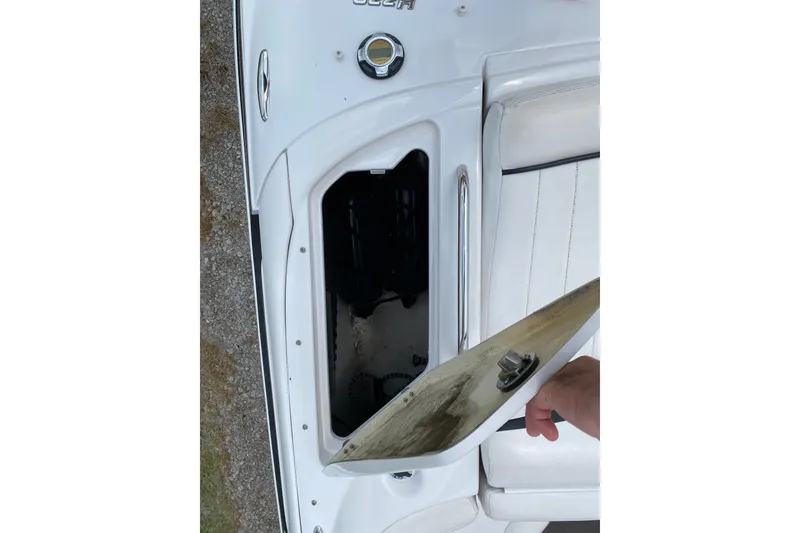 Slide: The Image of Open storage compartment on a 2008 Four Winns H220 boat, showcasing interior space. - 33