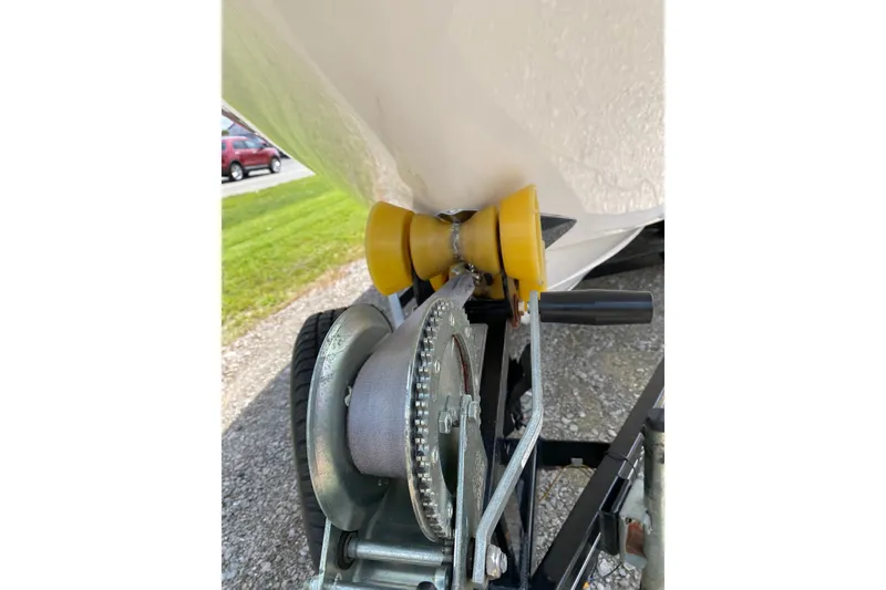 Slide: The Image of Close-up of a 2008 Four Winns H220 boat trailer winch and roller. - 23