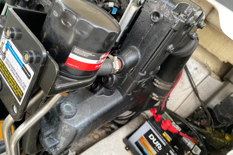 Slide: The Image of Engine compartment of a 2008 Four Winns H220 boat with visible oil filter and battery. - 46
