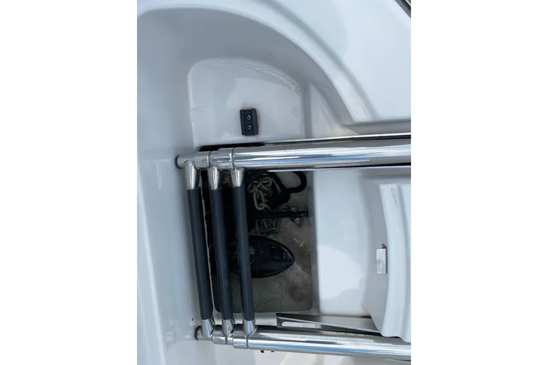 Slide: The Image of Stainless steel boat ladder on 2008 Four Winns H220, folded and secured. Anchor locker underneath with mushroom anchor and rope. - 76