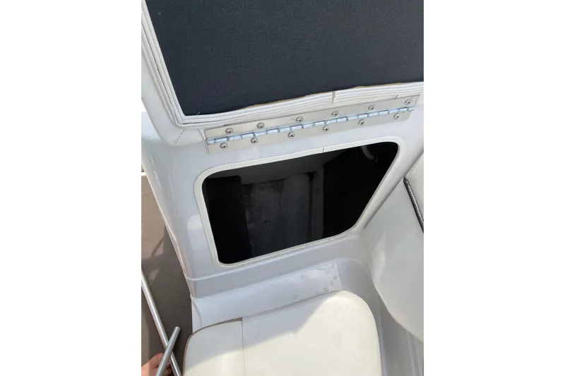 Slide: The Image of 2008 Four Winns H220 boat storage compartment with open hatch. - 58