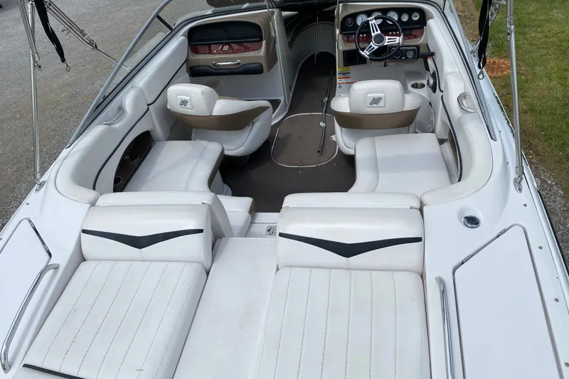 Slide: The Image of 2008 Four Winns H220 boat interior with white seating and modern dashboard. - 27