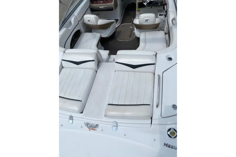 Slide: The Image of 2008 Four Winns H220 boat interior with white seating and sleek design. - 29