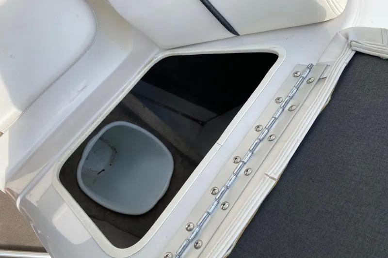 Slide: The Image of Open storage compartment on 2008 Four Winns H220 boat, featuring a white interior bucket. - 48