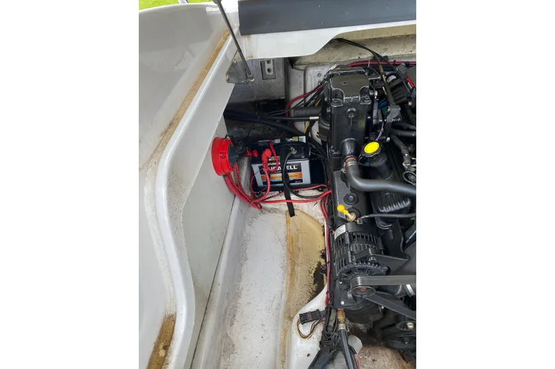 Slide: The Image of Engine compartment of a 2008 Four Winns H220 boat, showing battery and wiring. - 59