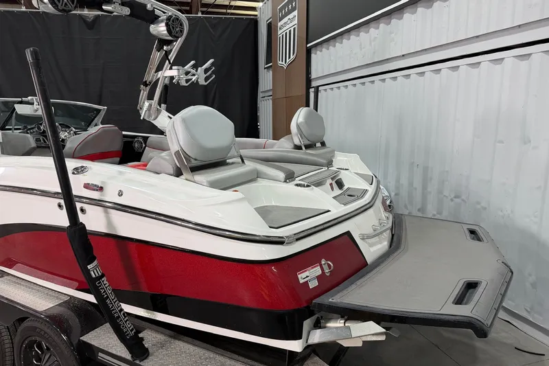 Slide: The Image of 2017 MasterCraft X46 boat with red and white exterior, displayed indoors. - 5