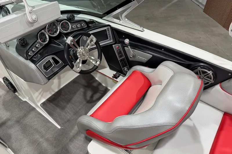 Slide: The Image of 2017 MasterCraft X46 boat interior with sleek dashboard and red-gray seating. - 9