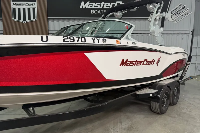 Slide: The Image of 2017 MasterCraft X46 boat with red and white design on a trailer. - 3