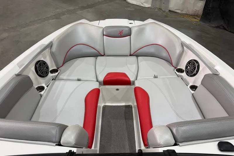 Slide: The Image of 2017 MasterCraft X46 boat interior with gray and red seating, cup holders, and speakers. - 10