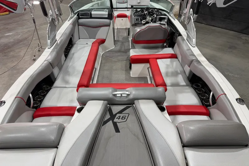 Slide: The Image of 2017 MasterCraft X46 boat interior with red and gray seating, showcasing luxury design. - 6