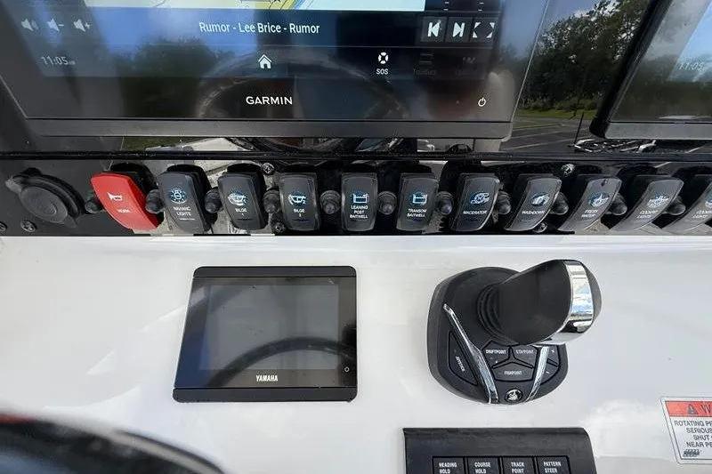 Slide: The Image of 2022 Sea Hunt Gamefish 27FS dashboard with Garmin display and Yamaha controls. - 52
