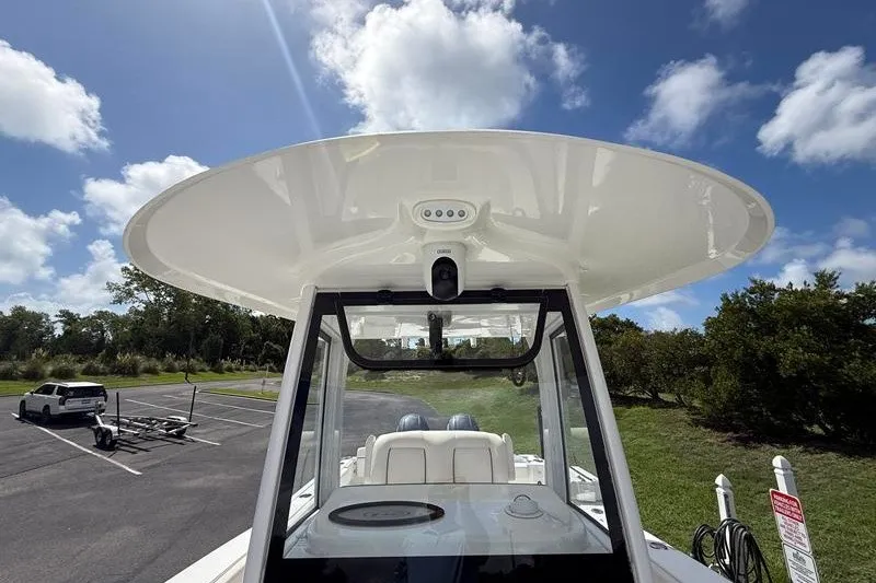 Slide: The Image of 2022 Sea Hunt Gamefish 27FS boat with T-top under a clear blue sky. - 61