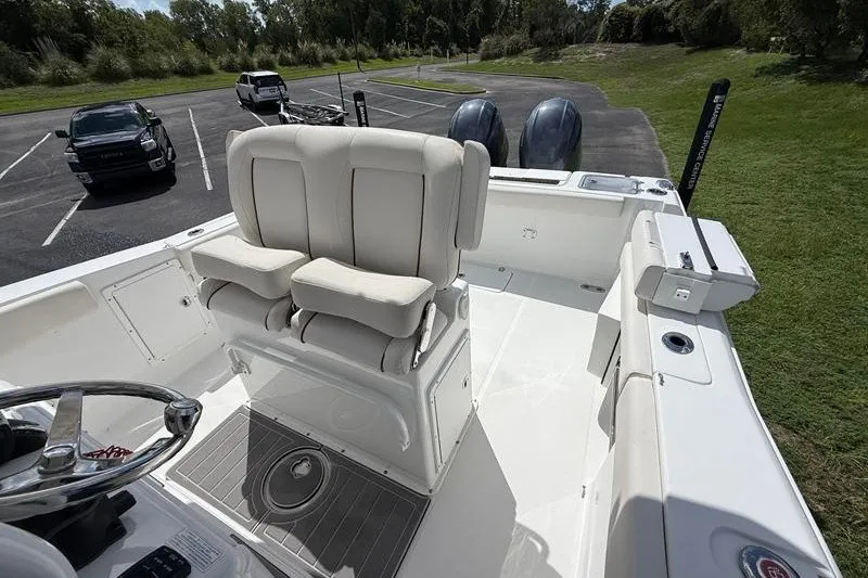 Slide: The Image of 2022 Sea Hunt Gamefish 27FS boat interior with dual seats and steering wheel. - 46