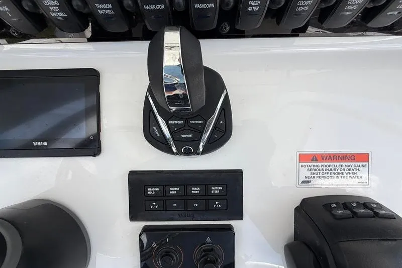 Slide: The Image of Control panel of 2022 Sea Hunt Gamefish 27FS boat with Yamaha controls and warning label. - 51