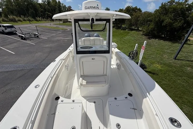 Slide: The Image of 2022 Sea Hunt Gamefish 27FS boat with Garmin equipment, parked on a sunny day. - 60