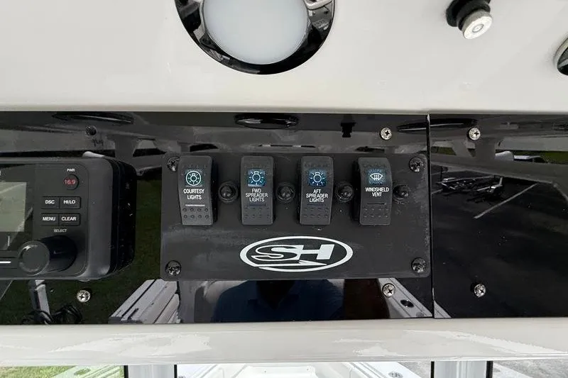 Slide: The Image of Control panel of 2022 Sea Hunt Gamefish 27FS boat with light switches. - 55