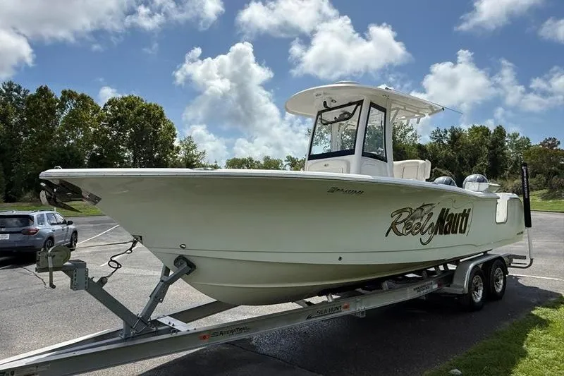 Slide: The Image of 2022 Sea Hunt Gamefish 27FS boat on trailer under cloudy sky. - 35