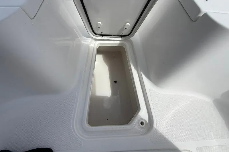 Slide: The Image of 2022 Sea Hunt Gamefish 27FS storage compartment, open and empty, showcasing interior space. - 64
