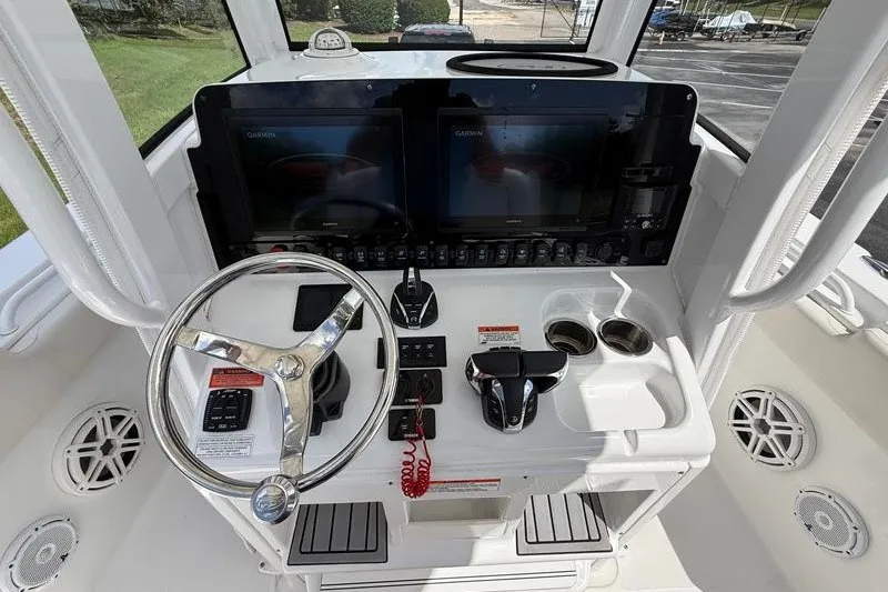 Slide: The Image of 2022 Sea Hunt Gamefish 27FS boat dashboard with dual Garmin displays and steering wheel. - 47