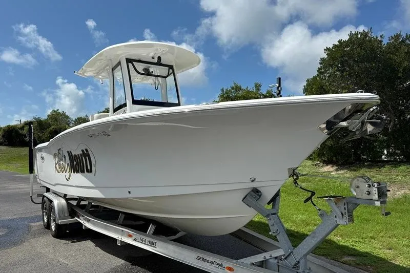 Slide: The Image of 2022 Sea Hunt Gamefish 27FS boat on trailer under blue sky. - 36