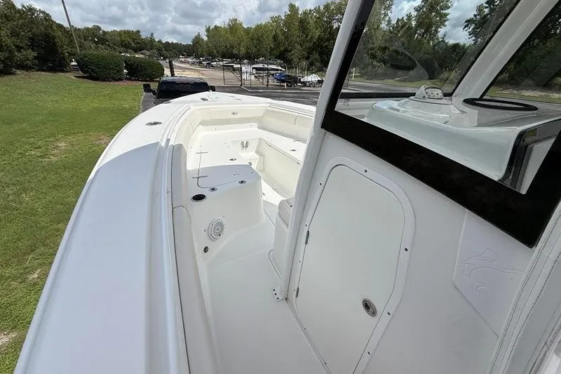 Slide: The Image of 2022 Sea Hunt Gamefish 27FS boat interior with seating and storage compartments. - 57
