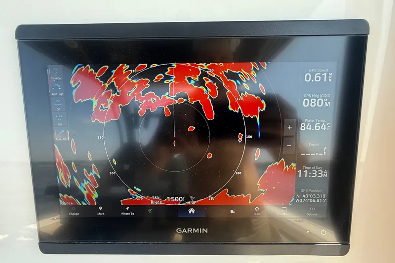 Slide: The Image of Garmin marine radar display on 2019 Tidewater 320 CC Adventure boat, showing navigation data. - 12