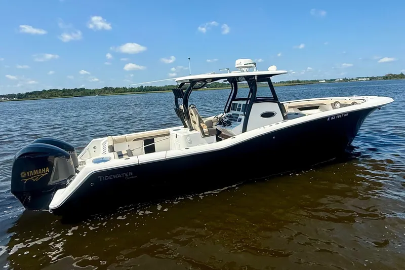 The Image of 2019 Tidewater 320 CC Adventure boat on calm water, featuring Yamaha engines. - 0