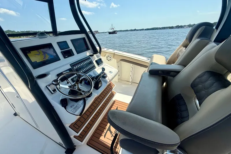 Slide: The Image of 2019 Tidewater 320 CC Adventure boat cockpit with advanced navigation controls and comfortable seating. - 3