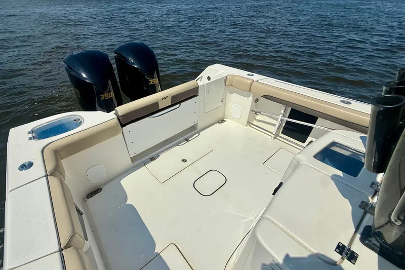 Slide: The Image of 2019 Tidewater 320 CC Adventure boat with twin 350 engines on open water. - 22