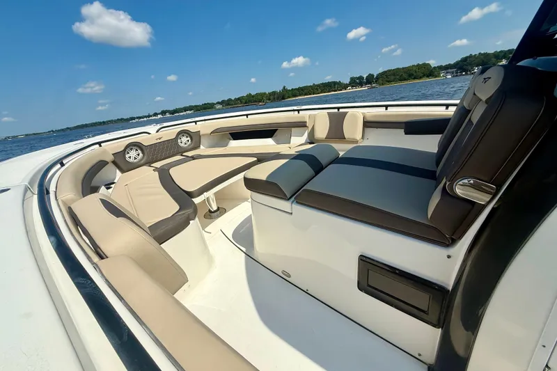 Slide: The Image of 2019 Tidewater 320 CC Adventure boat interior with luxurious seating on a sunny day. - 35