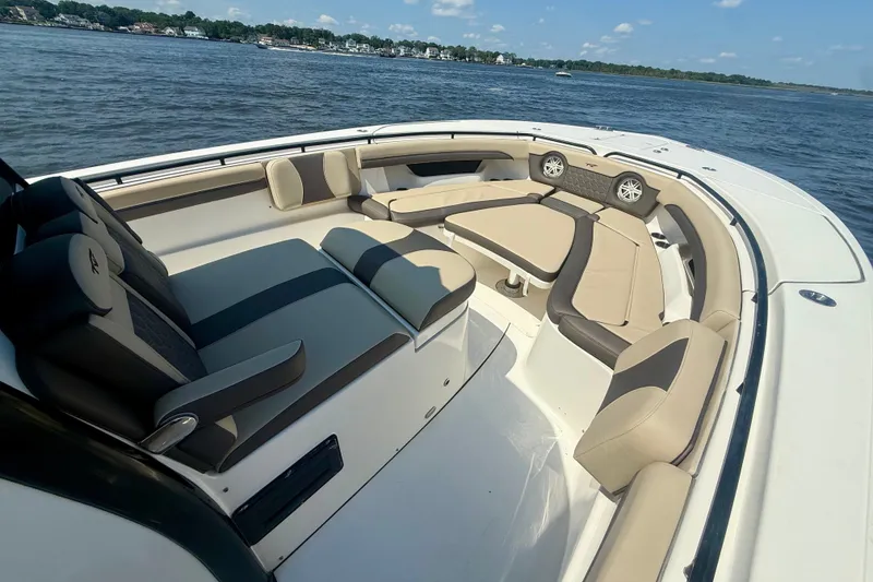 Slide: The Image of 2019 Tidewater 320 CC Adventure boat interior with spacious seating and scenic water view. - 34