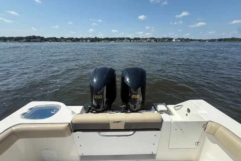 Slide: The Image of 2019 Tidewater 320 CC Adventure boat with twin 350 engines on a calm lake. - 20