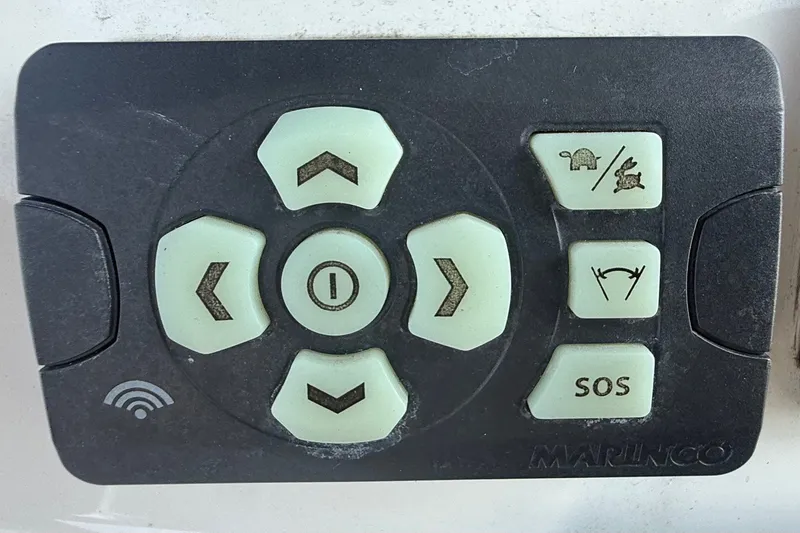 Slide: The Image of Control panel for 2019 Tidewater 320 CC Adventure boat with directional and SOS buttons. - 7
