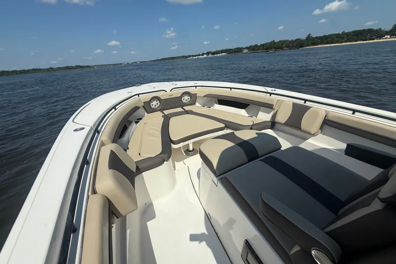 Slide: The Image of 2019 Tidewater 320 CC Adventure boat with spacious seating on calm water. - 36