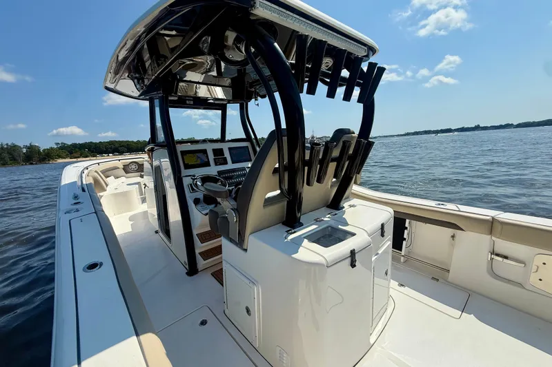 Slide: The Image of 2019 Tidewater 320 CC Adventure boat on calm waters, showcasing sleek design and modern features. - 15