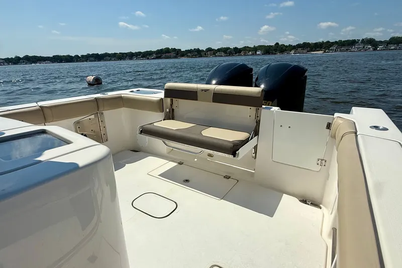 Slide: The Image of 2019 Tidewater 320 CC Adventure boat interior with seating, on a sunny day at sea. - 17