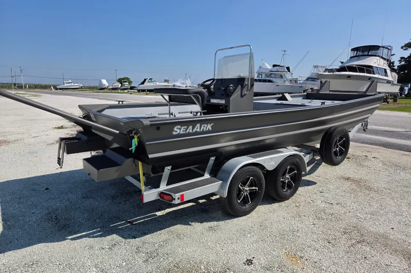 The Image of 2026 SeaArk 2072 Workhorse boat on trailer, parked in marina under clear sky. - 0