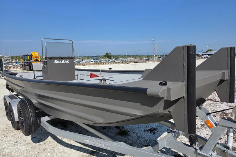 Slide: The Image of 2026 SeaArk 2072 Workhorse boat on trailer, displayed outdoors under clear blue sky. - 6