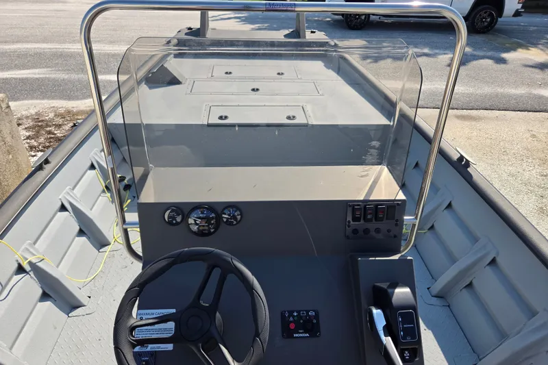 Slide: The Image of 2026 SeaArk 2072 Workhorse boat interior with steering console and controls. - 9