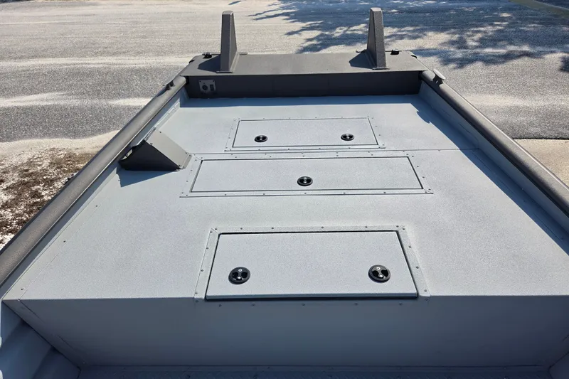 Slide: The Image of 2026 SeaArk 2072 Workhorse boat deck with storage compartments, shown in a parking area. - 10