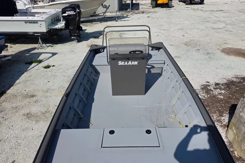 Slide: The Image of 2026 SeaArk 2072 Workhorse boat, gray interior, parked on gravel lot. - 3