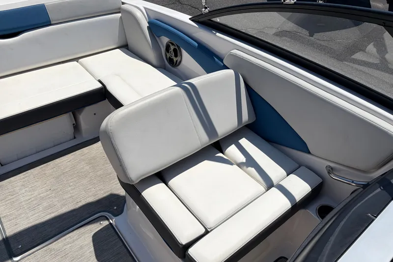 Slide: The Image of 2016 Regal 1900 ESX Bowrider interior with white and blue seating, cup holder, and speaker. - 15