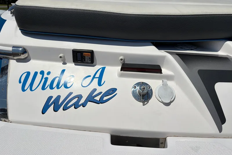 Slide: The Image of 2016 Regal 1900 ESX Bowrider boat with "Wide A Wake" decal on the stern. - 27