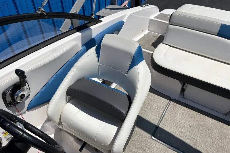Slide: The Image of 2016 Regal 1900 ESX Bowrider interior with white and blue seating, steering wheel, and controls. - 14